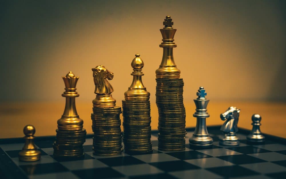 Chess pieces standing on stacks of coins, from ALOT's 2024 material