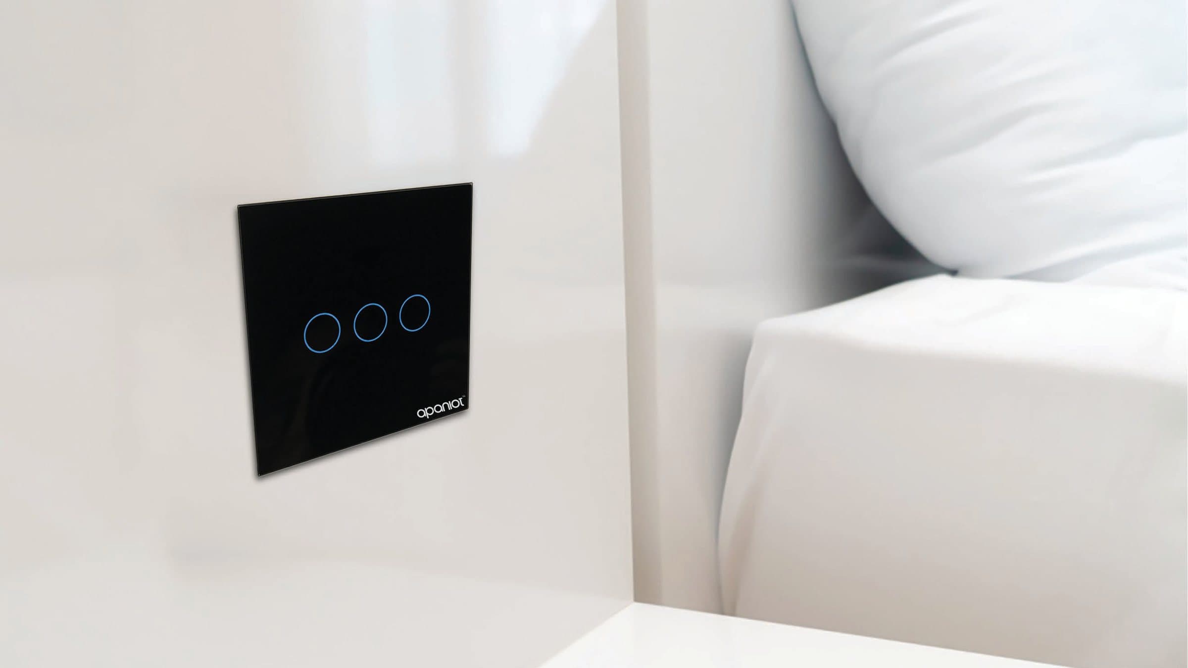 Apaniot CH-A3 glass touch switch installed on a white wall beside a bed